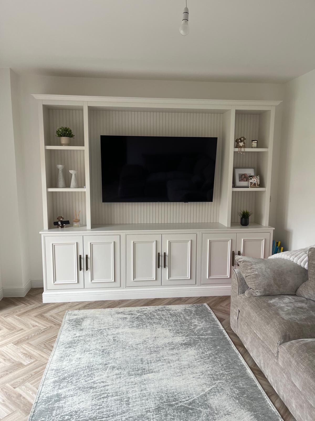 Bespoke alcove cabinets and shelving flanking a fireplace